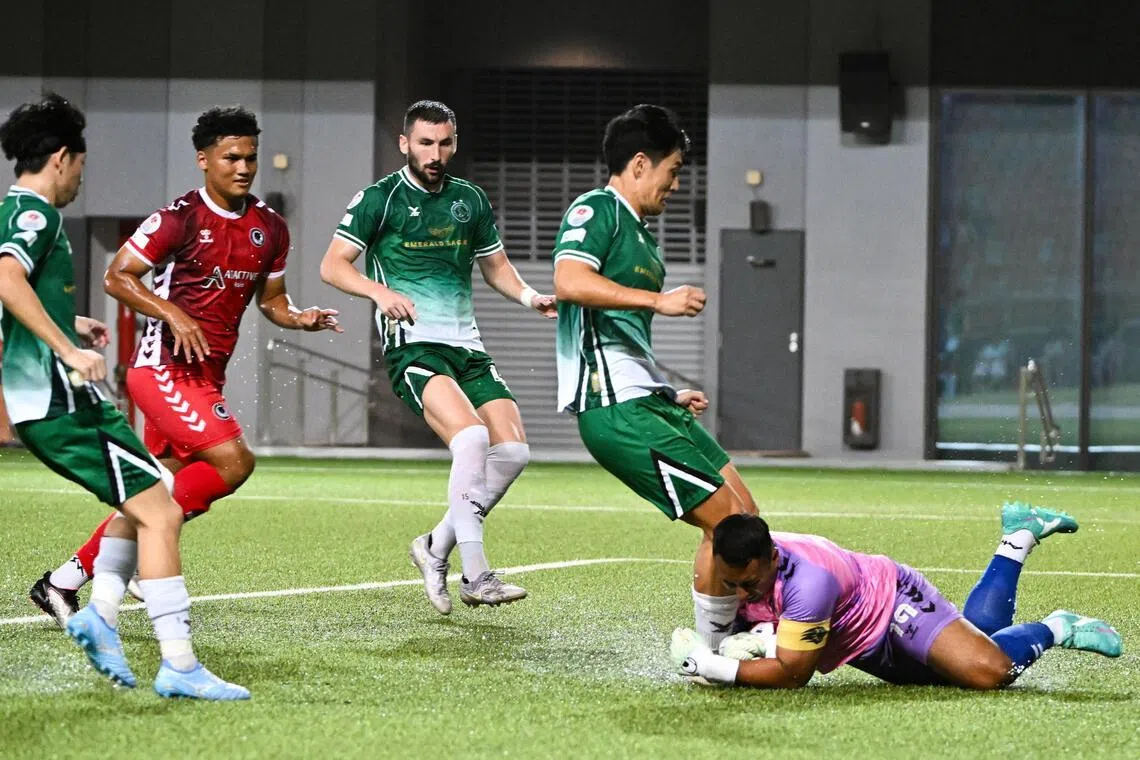 Tanjong Pagar United Goalkeeper Zaiful Nizam (right) saving the ball and was injured in the process as Geylang International forward Shuhei Hoshino (second from right) attacks a 50-50 ball.