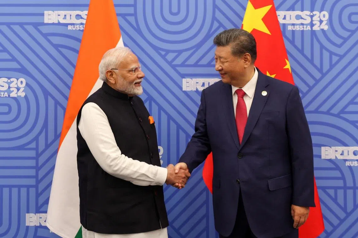 India PM Narendra Modi and Chinese President Xi Jinping meet on the sidelines of the BRICS summit in Kazan, Russia, on Oct 23.