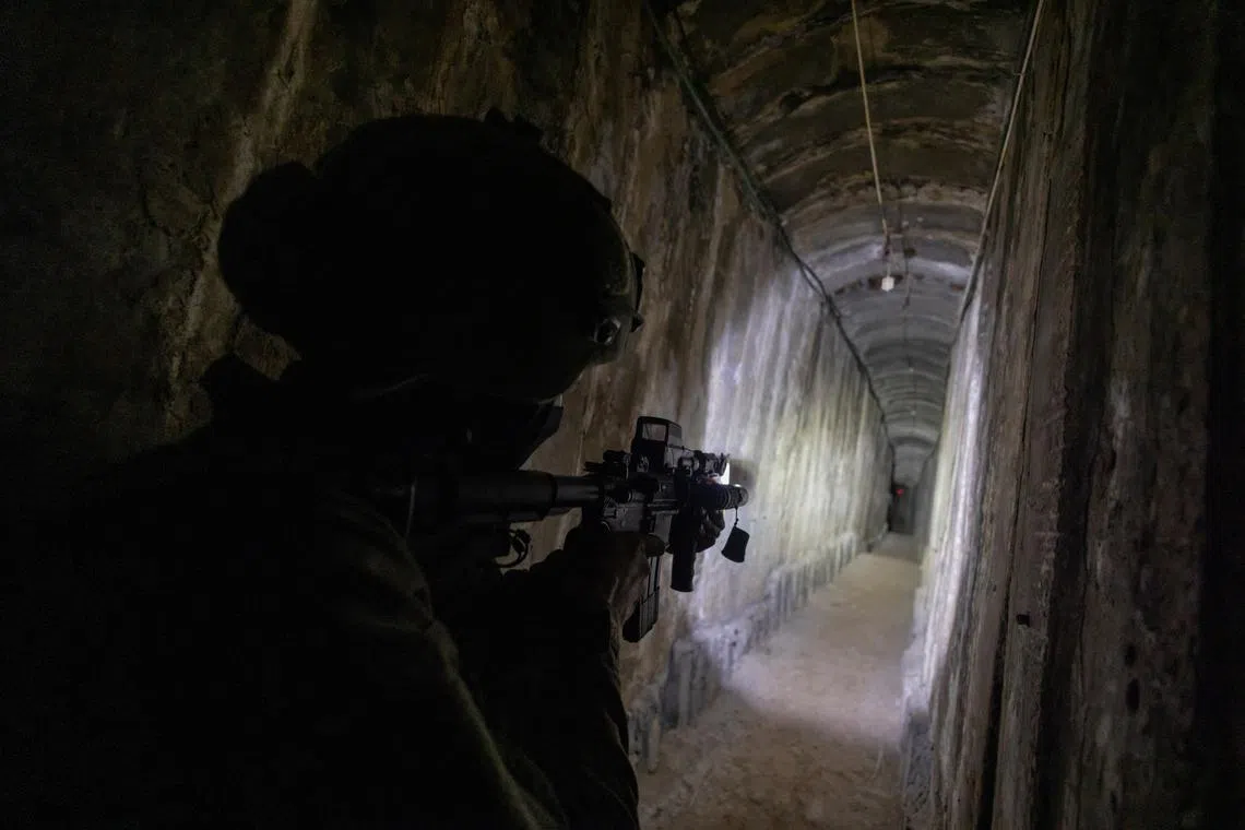An Israeli soldier secures a tunnel underneath Al Shifa Hospital, amid the ground operation of the Israeli army against Hamas, in the northern Gaza Strip, November 22, 2023. Reuters photographers embedded with the Israeli Defence Forces are required, as a condition of their presence, to submit those images for review before publication. No photos were removed by the IDF from this embed.   REUTERS/Ronen Zvulun          Pulitzer Prize Winner for Breaking News Photography