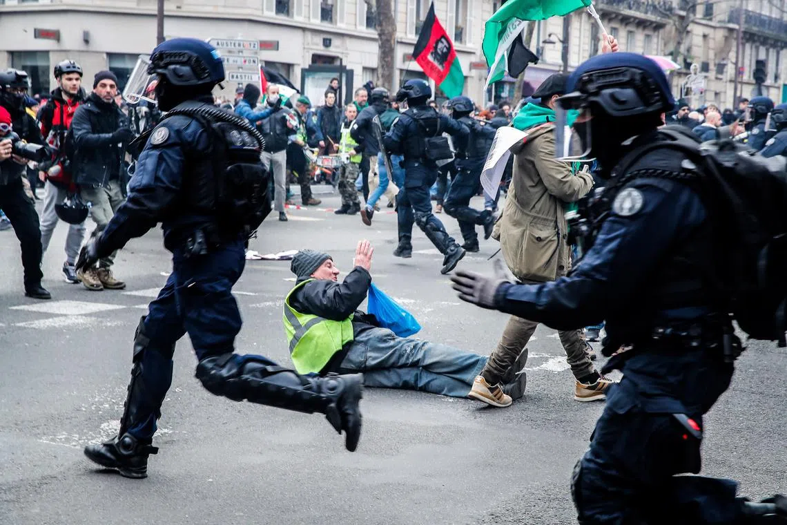 Police charge demonstrators, during a protest in Paris against reform of the pensions system, on March 11, 2023.