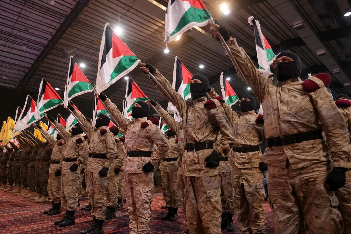 Hezbollah members stand in formation during a gathering to mark annual Quds (Jerusalem) Day commemorations in Beirut's southern suburb on April 5, 2024. (Photo by ANWAR AMRO / AFP)