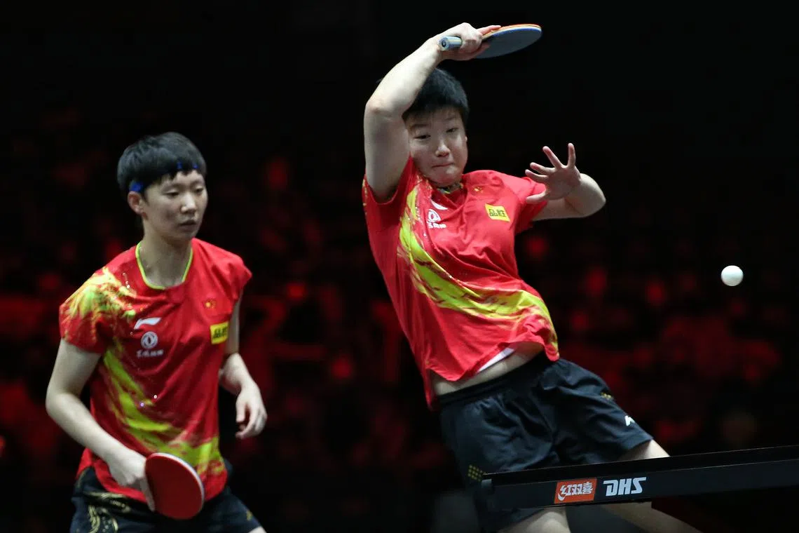 China's Wang Manyu (left) and Sun Yingsha in action at the WTT Singapore Smash women's doubles finals, on March 19, 2022.