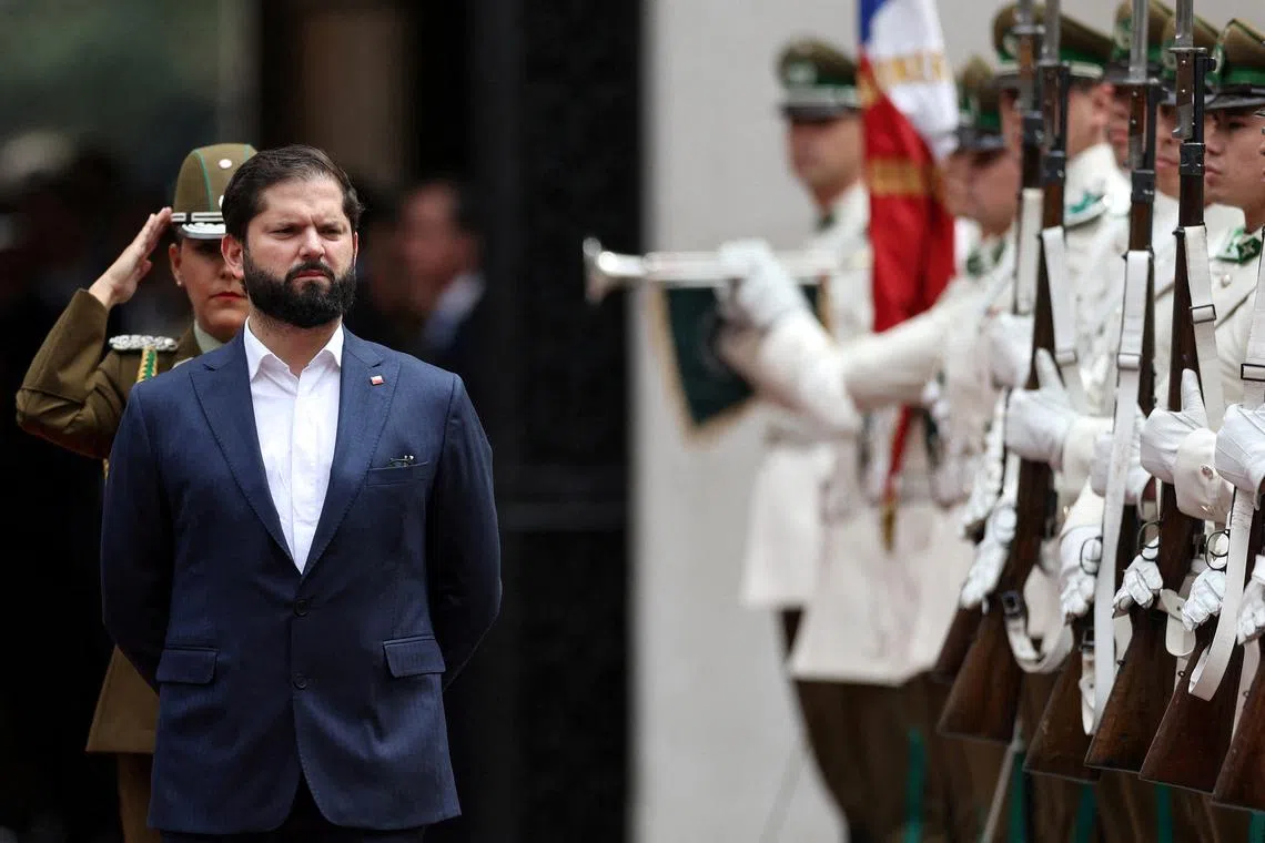 FILE PHOTO: Chile's President Gabriel Boric walks past an honor guard at La Moneda government palace, in Santiago, Chile November 20, 2024. REUTERS/Ivan Alvarado/File Photo