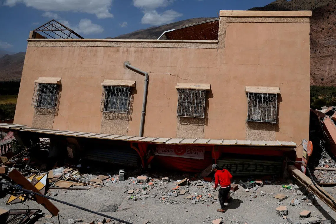 A person stands amidst rubble near a damaged building, in the aftermath of a deadly earthquake in Talat N'Yaaqoub, Morocco September 15, 2023. REUTERS/Ammar Awad     TPX IMAGES OF THE DAY     