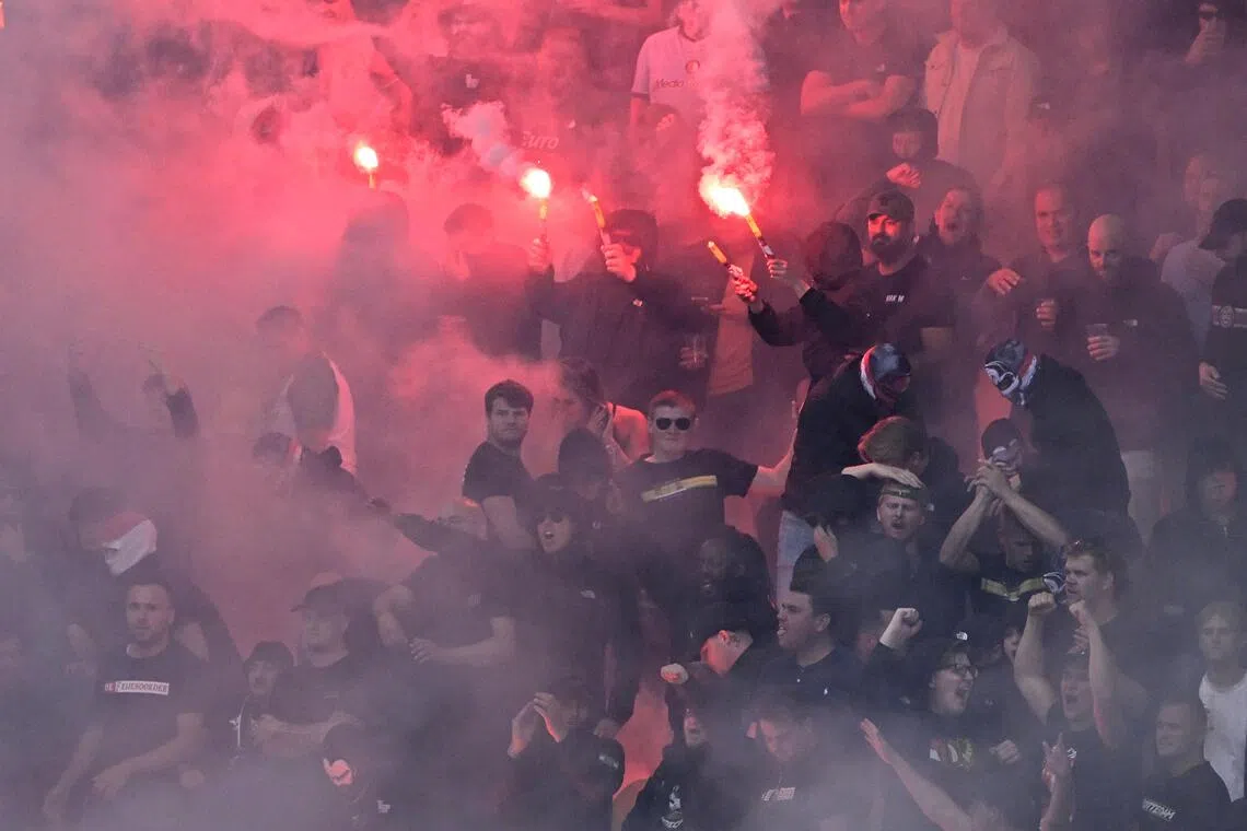 Feyenoord fans setting off flares during the Dutch Eredivisie match against SC Cambuur at the Kooi Stadion in Leeuwarden, the Netherlands on Aug 23.