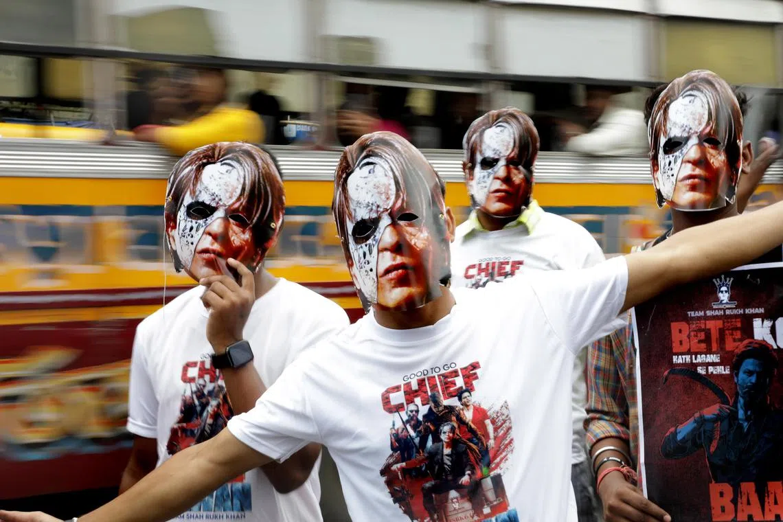 epa10845643 Bollywood star Shah Rukh Khan fans wear masks from his new film 'Jawan' as they celebrate its release day in Kolkata, India, 07 September 2023. Hundreds of Shah Rukh fans walk a rally to celebrate the release in several places in Kolkata.  EPA-EFE/PIYAL ADHIKARY