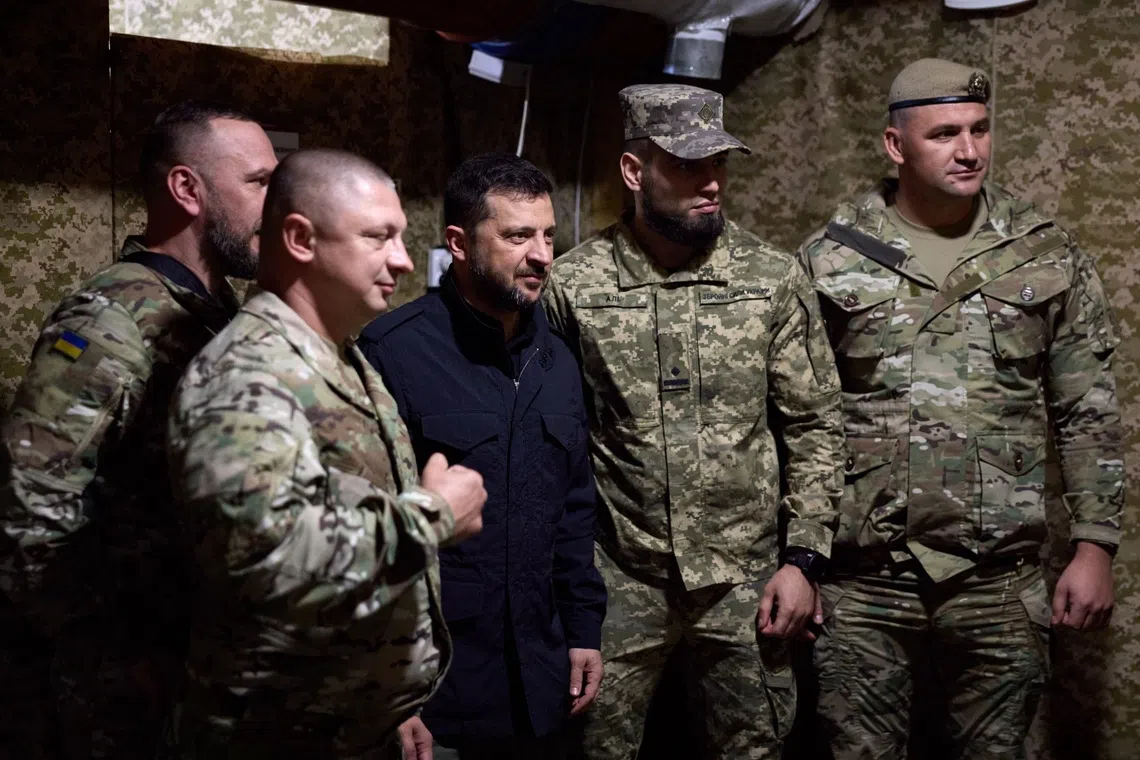 Ukrainian President Volodymyr Zelensky (centre) visiting front-line troops on Sept 18.