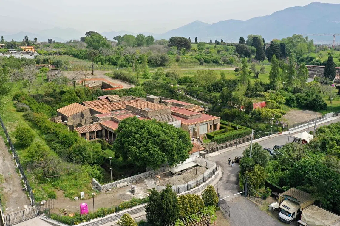 An aerial view shows the 'Villa of Mysteries' which has been partly retiled with solar panels, on April 15, 2024 in Pompeii. The photovoltaic tiles look just like the ancient tiles of Pompeii but have solar cells inside, allowing the UNESCO World Heritage Site to preserve its aesthetics while generating clean energy to illuminate its frescoes.
The project is in its early stages but experts say the tiles could one day play a part in helping historic centres across Italy turn green. The scheme weds emerging technologies with extraordinary murals unearthed in 1909 from under metres of volcanic ash at the Villa of the Mysteries, buried along with the rest of the city when Vesuvius erupted nearly 2,000 years ago. (Photo by Andreas SOLARO / AFP)