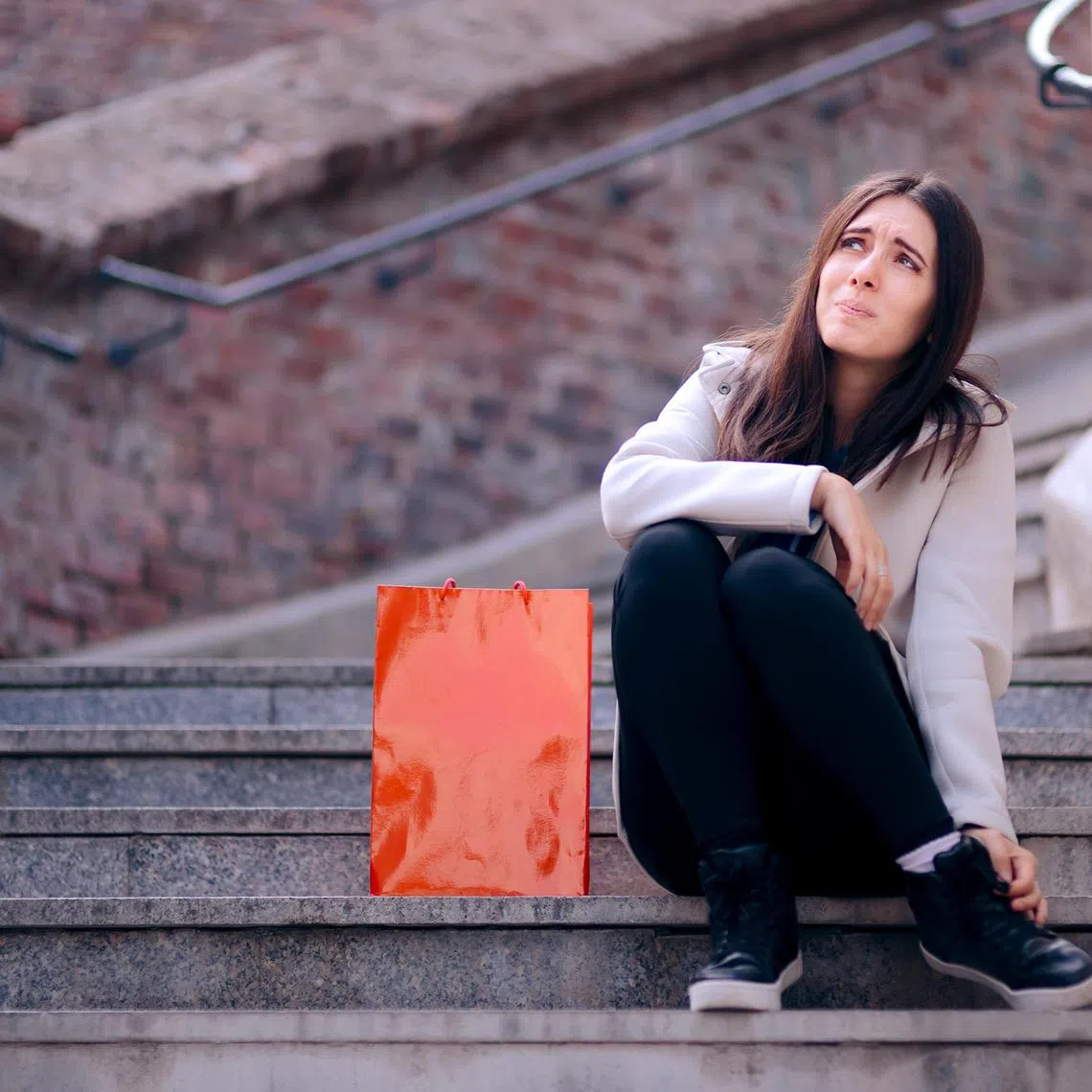 Shopaholic girl feeling exhausting after shopping spree