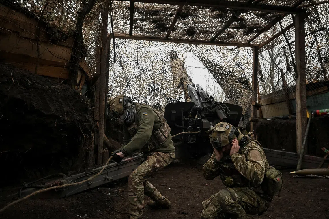 Artillerymen of the 152nd Separate Jaeger Brigade fire a howitzer towards Russian troops, amid Russia's attack on Ukraine, near the frontline town of Pokrovsk in Donetsk region, Ukraine December 11, 2025. REUTERS/Stringer