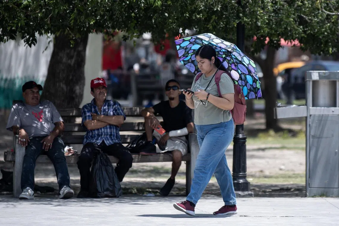 People in the city of Monterrey protecting themselves from the sun. The north of the country has seen temperatures exceed 40 deg C.