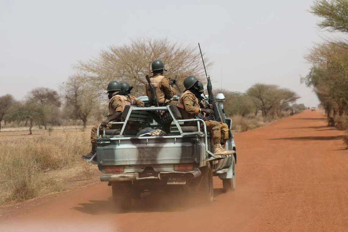 FILE PHOTO: Soldiers from Burkina Faso patrol on the road of Gorgadji in the Sahel area, Burkina Faso March 3, 2019.REUTERS/Luc Gnago/File Photo