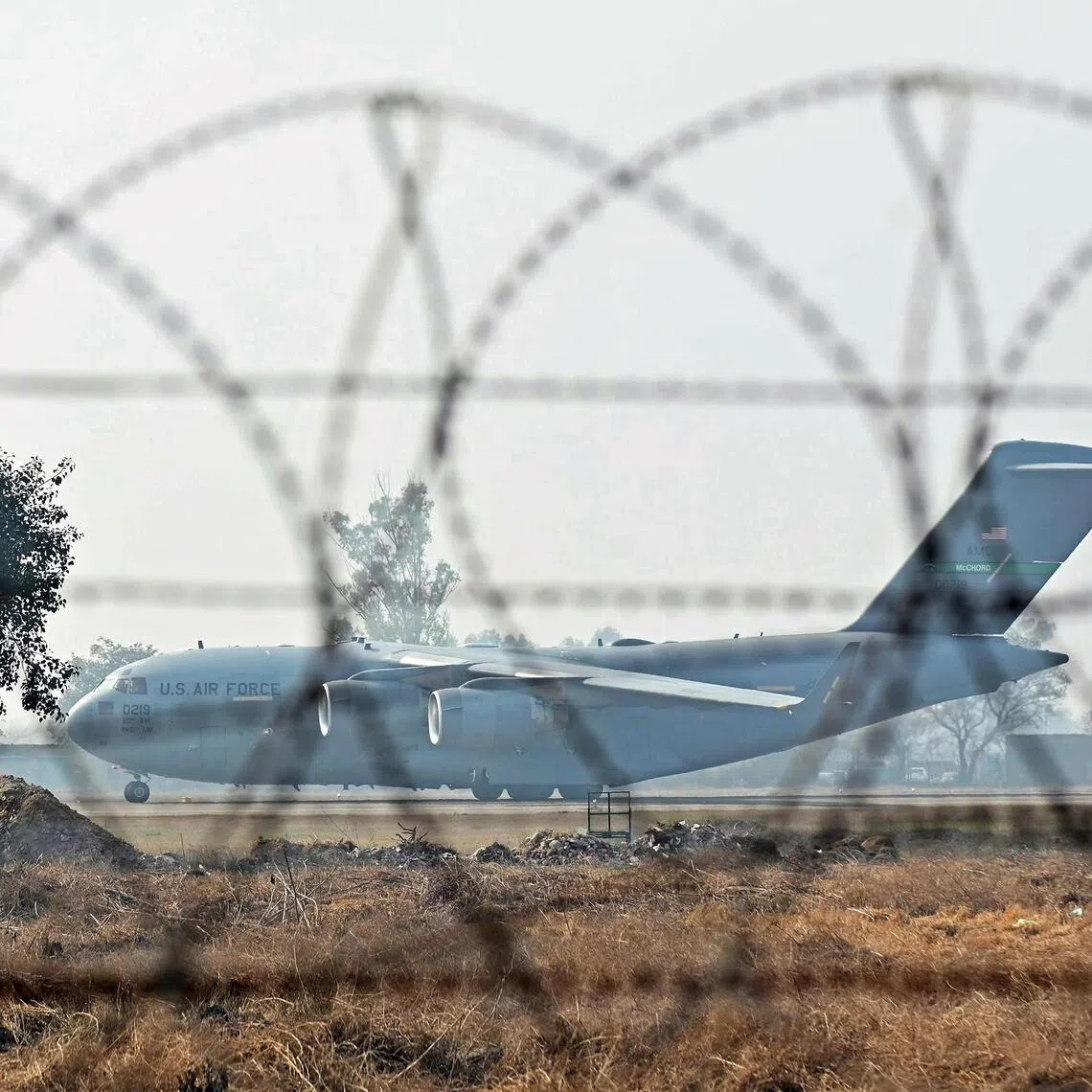 A US Air Force aircraft carrying Indian migrants deported from the United States, lands at the Guru Ram Das Jee International Airport in Amritsar on Feb 5, 2025.