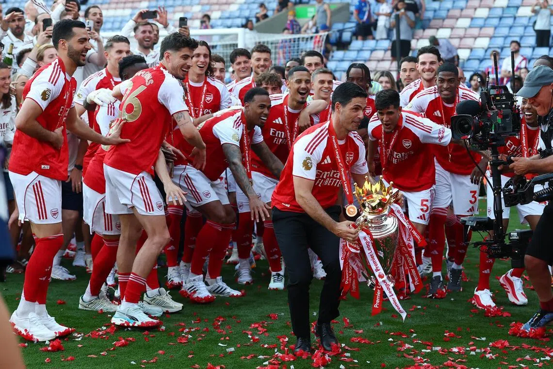 Soccer Football - Premier League - Crystal Palace v Arsenal - Selhurst Park, London, Britain - May 24, 2026
Arsenal manager Mikel Arteta with the trophy as he celebrates with players after winning the Premier League Action Images via Reuters/Matthew Childs EDITORIAL USE ONLY. NO USE WITH UNAUTHORIZED AUDIO, VIDEO, DATA, FIXTURE LISTS, CLUB/LEAGUE LOGOS OR 'LIVE' SERVICES. ONLINE IN-MATCH USE LIMITED TO 120 IMAGES, NO VIDEO EMULATION. NO USE IN BETTING, GAMES OR SINGLE CLUB/LEAGUE/PLAYER PUBLICATIONS. PLEASE CONTACT YOUR ACCOUNT REPRESENTATIVE FOR FURTHER DETAILS..