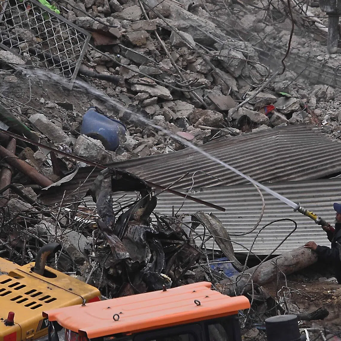 Firefighters work at Gul Plaza after a fire in Karachi, Pakistan, on Jan 22, 2026.
