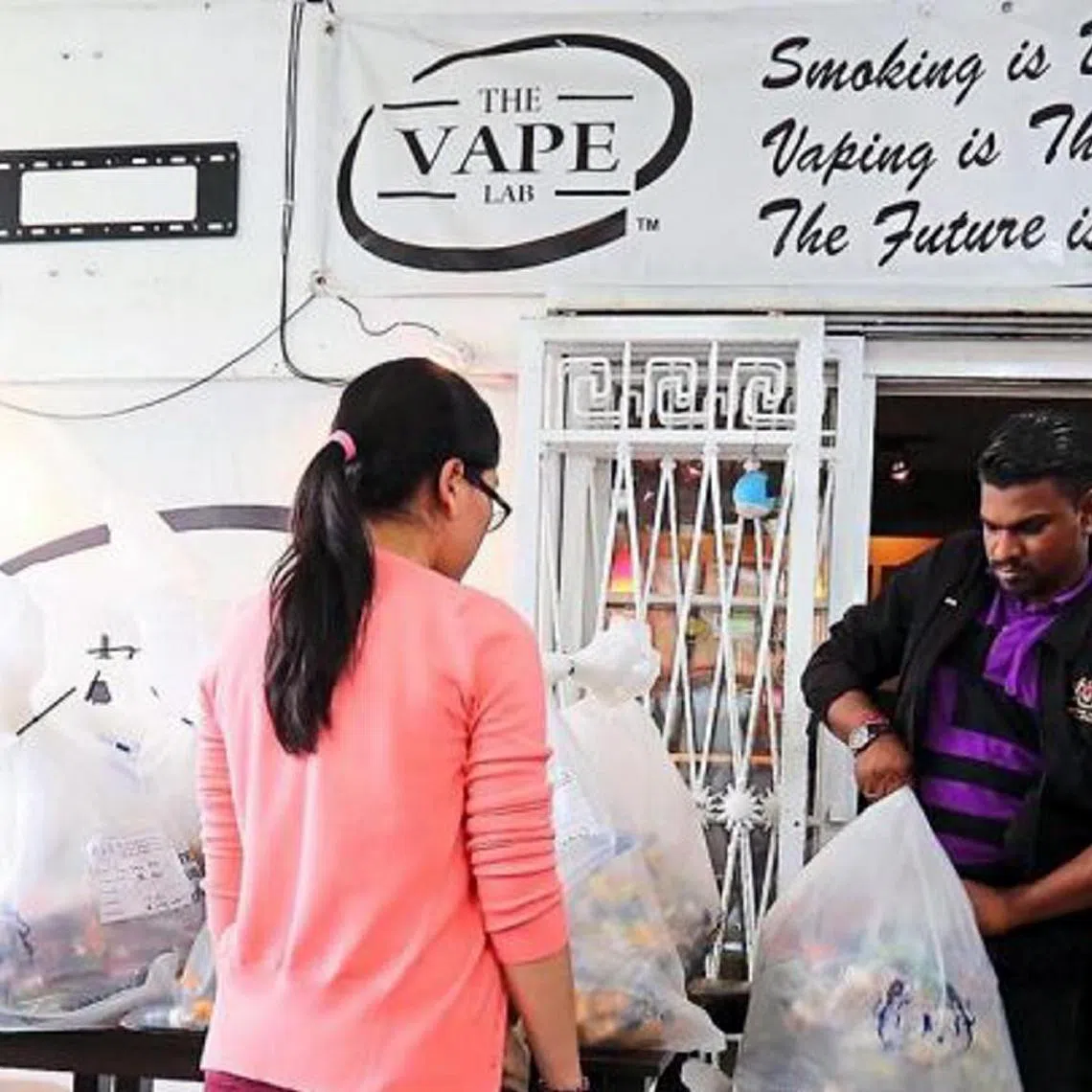 Malaysian authorities taking away seized vape liquids and related products in a joint raid at an outlet in Johor Baru. The crackdown on vape sellers in Malaysia has begun, starting with those selling nicotine-laced liquids, ahead of the Jan 1 ban on vapes in the state. Police, aided by state and federal agencies, raided three outlets, two in Taman Century and one in Larkin, seizing RM380,385 worth of products. Nicotine is listed in the Poisons Act and products containing it can only be sold by pharmacists.