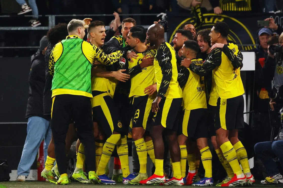 Soccer Football - Bundesliga - Borussia Dortmund v St. Pauli - Signal Iduna Park, Dortmund, Germany - January 17, 2026 Borussia Dortmund's Emre Can Jones celebrates scoring their third goal with teammates REUTERS/Thilo Schmuelgen