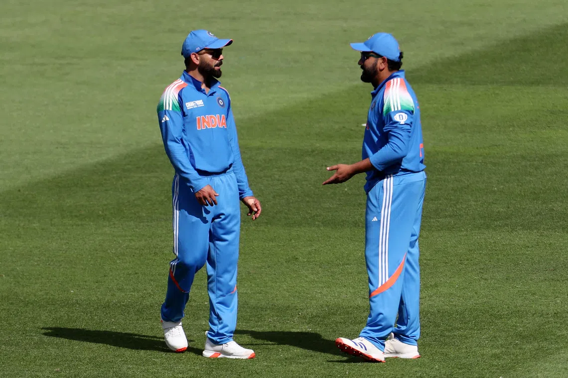 Cricket - ICC Men's Champions Trophy - Group A - India v Pakistan - Dubai International Stadium, Dubai, United Arab Emirates - February 23, 2025 India's Rohit Sharma reacts with Virat Kohli REUTERS/Satish Kumar