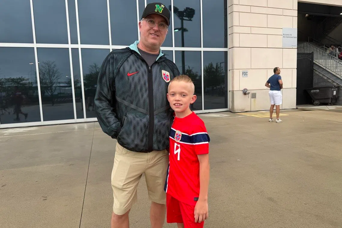 Soren Alan, 10, alongside his father Jeremy Alan, 52, before the match. Soren idolises Erling Haaland.