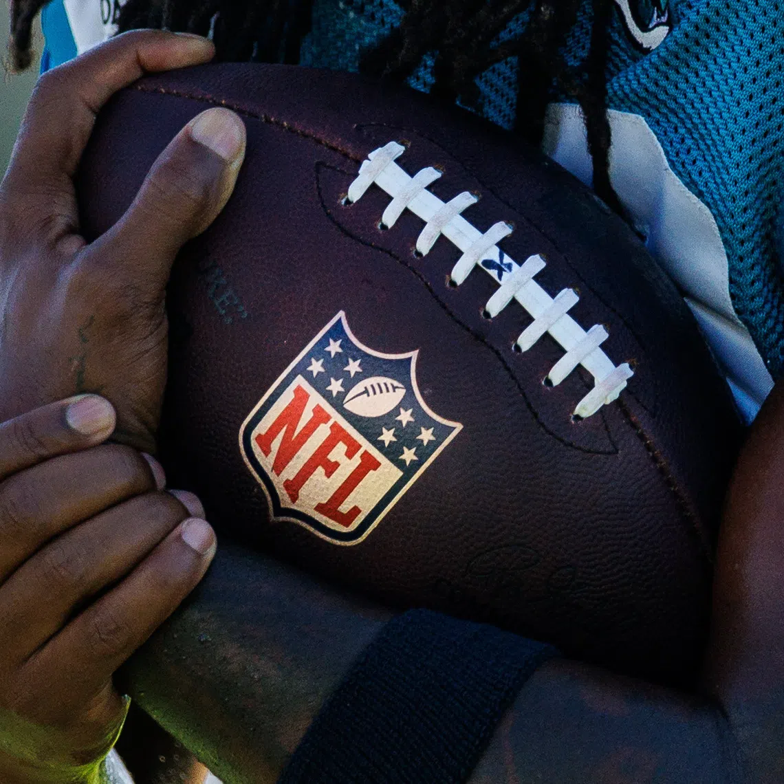 Aug 13, 2026; Metairie, LA, USA;  Detailed view of the NFL logo on the football during a joint scrimmage between the New Orleans Saints and the Jacksonville Jaguars during at Ochsner Sports Performance Center. Mandatory Credit: Stephen Lew-Imagn Images/File Photo