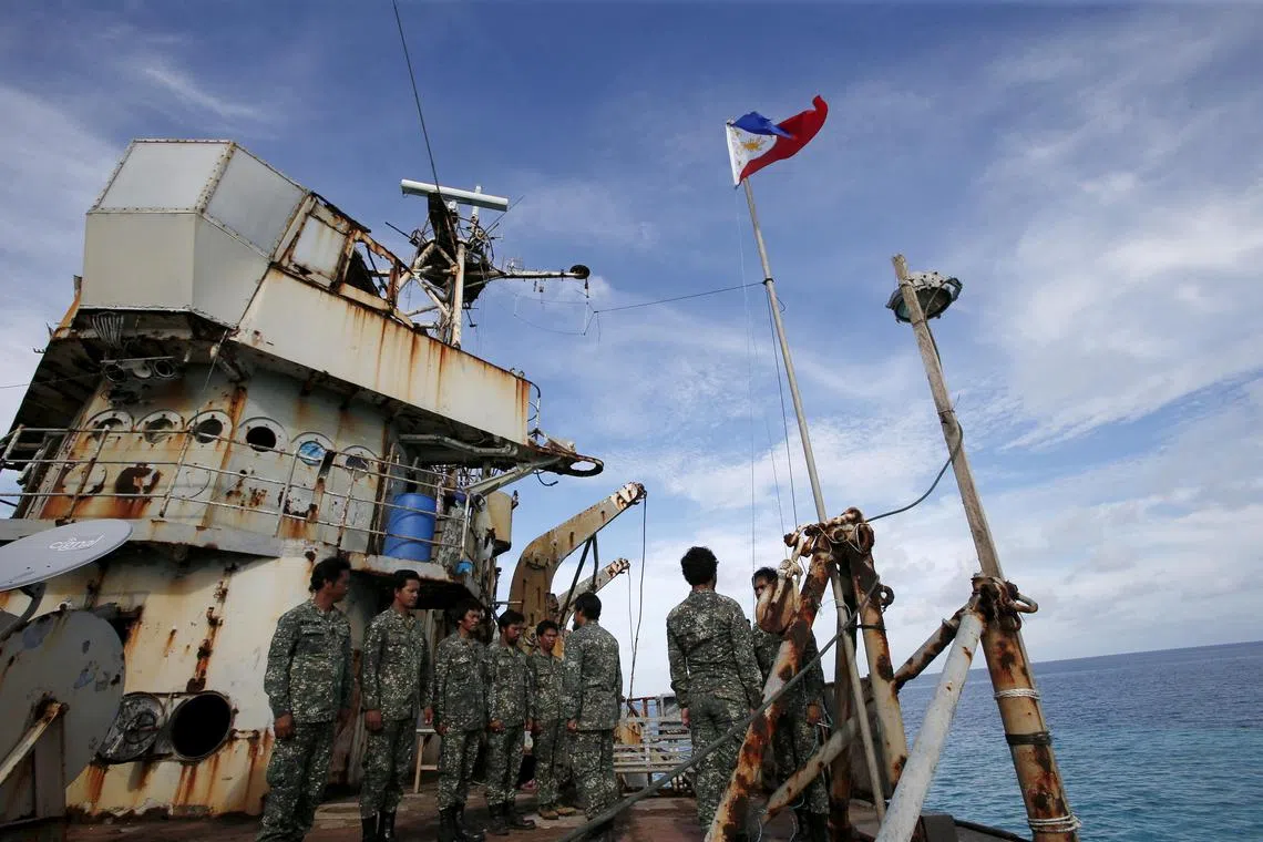 FILE PHOTO: Members of Philippine Marines is pictured at BRP Sierra Madre, a dilapidated Philippine Navy ship that has been aground since 1999 and became a Philippine military detachment on the disputed Second Thomas Shoal, part of the Spratly Islands, in the South China Sea March 29, 2014. Picture taken March 29, 2014.  REUTERS/Erik De Castro/File Photo