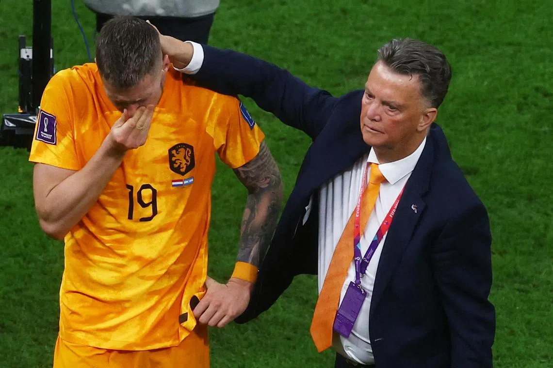 Netherlands coach Louis van Gaal and Wout Weghorst look dejected after the penalty shootout loss to Argentina on Friday. 