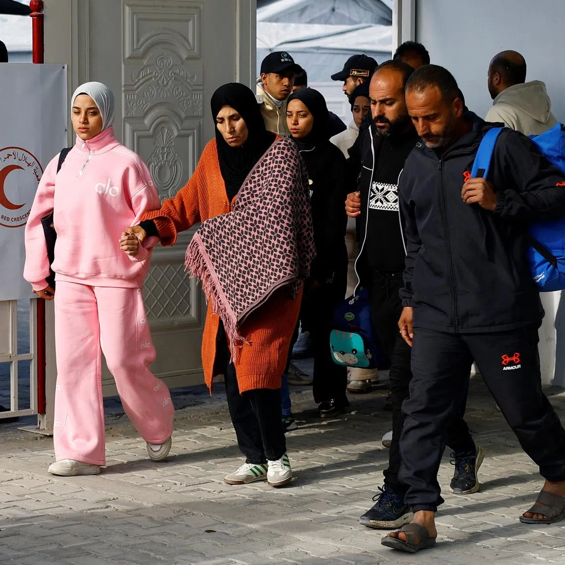 A Palestinian patient and her relatives head back home after being informed by officials that their travel through the Rafah border crossing was postponed, in Khan Younis, on Feb 4, 2026.
