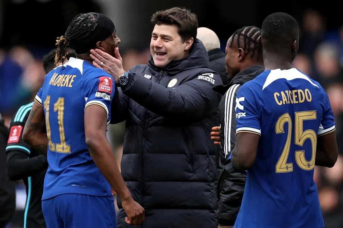 FILE PHOTO: Soccer Football - FA Cup - Quarter Final - Chelsea v Leicester City - Stamford Bridge, London, Britain - March 17, 2024 Chelsea manager Mauricio Pochettino celebrates with Noni Madueke after the match Action Images via Reuters/Andrew Boyers/File Photo