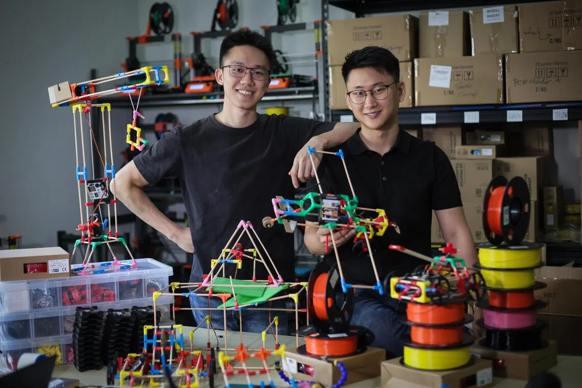 ST20250807_202546400940: Gin Tay/ sastick/ Sarah Koh/
Portraits of co-founders of Stick 'Em, Huh Dam (Adam), 27; and Chong Ing Kai, (left) 22; posing with Stick 'Em robotics kits at their SUTD office on Aug 7, 2025.