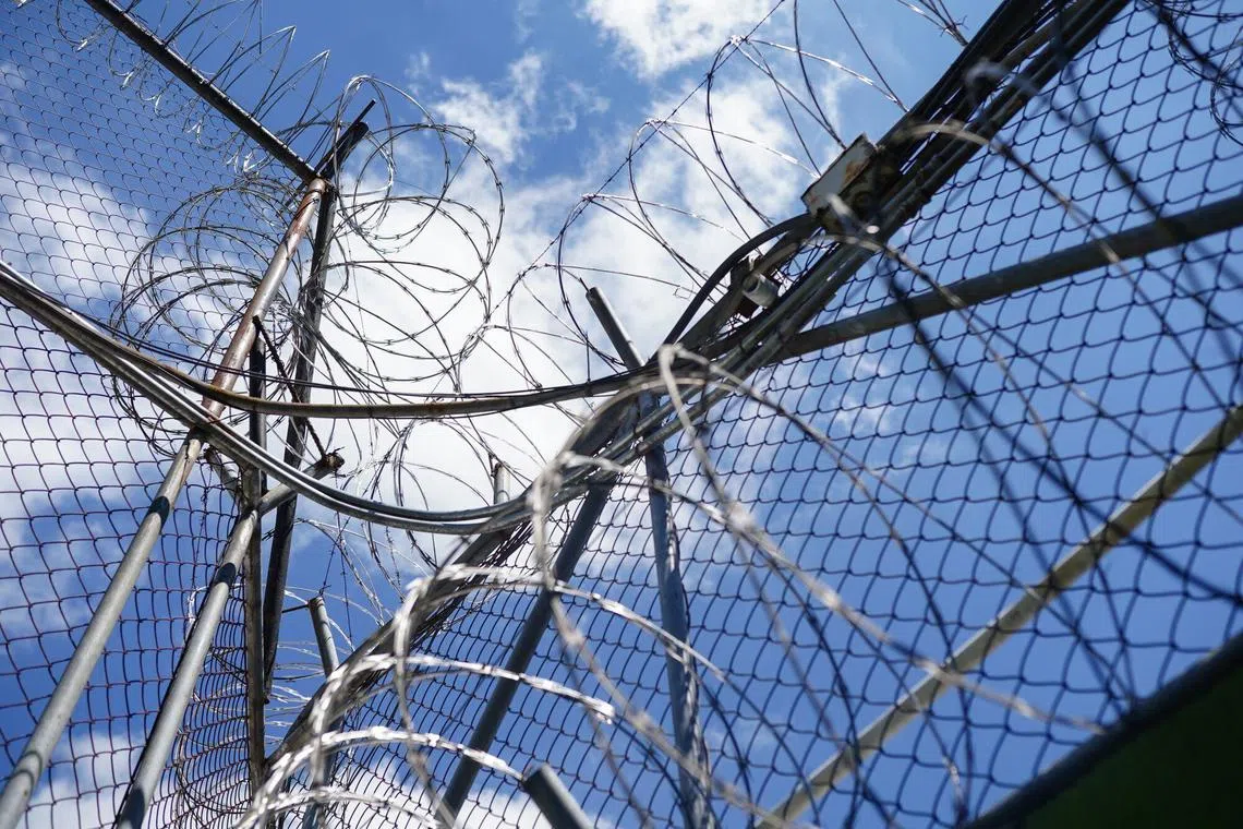 A razor wire fence at the La Esperanza Penitentiary Complex in San Salvador, El Salvador, on Thursday, Aug. 29, 2024. Two and half year's following President Nayib Bukele's crime crackdown, El Salvador has remained in a state of exception that has transformed the nation from one of the most dangerous countries in Latin America to among the safest, while simultaneously alarming human-rights groups that have condemned mass arrests and what they say are other abuses of civil liberties. Photographer: Camilo Freedman/Bloomberg