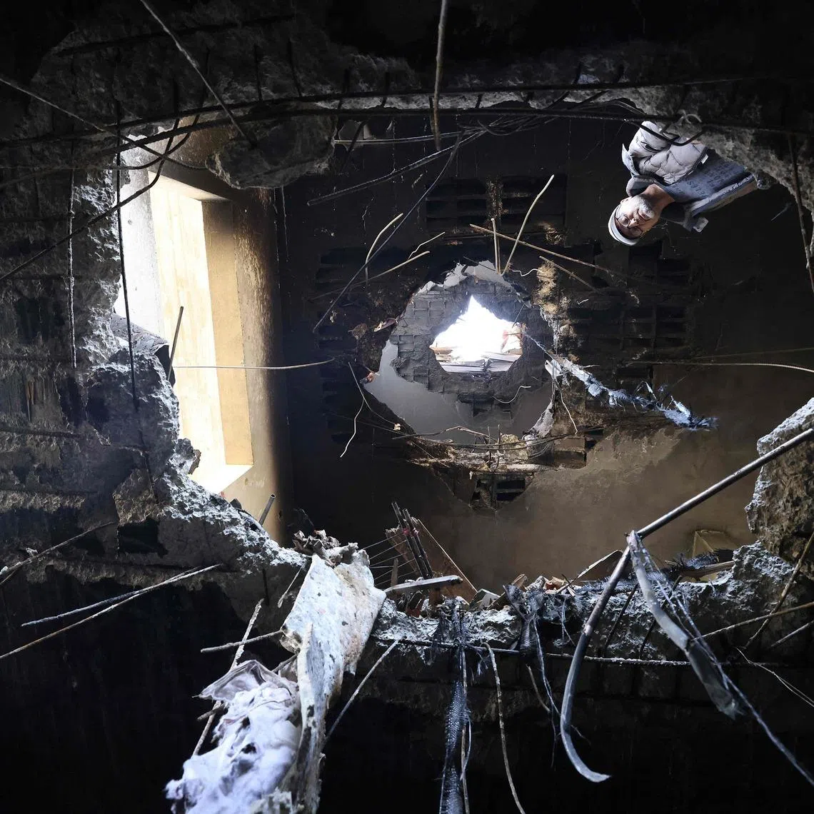 A Palestinian man looking at damage which according to residents was caused by fragments of an intercepted Iranian rocket that landed on a Palestinian three-storey building in the West Bank town of Bidya on March 11. 