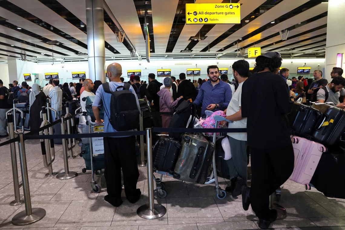 FILE PHOTO: Travellers queue to check in at Heathrow Airport Terminal 4, following a disruption to check-in and boarding systems caused by a cyberattack which has affected several major European airports, resulting in flight delays and cancellations, in Greater London, Britain, September 20, 2025. REUTERS/Isabel Infantes/File Photo
