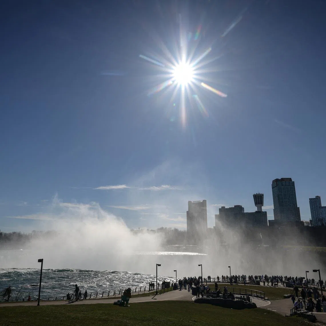 Tourists look at the Horseshoe Falls, ahead of the Solar Eclipse that will take place across parts of the United States and Canada on April 8, at Niagara Falls.