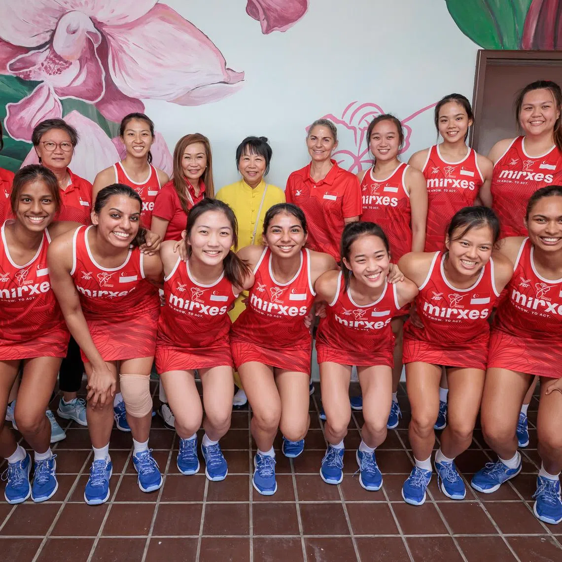 Ms Jane Ittogi (in yellow), spouse of President Tharman Shanmugaratnam, with the national netball team at Kallang Netball Centre on Aug 3.