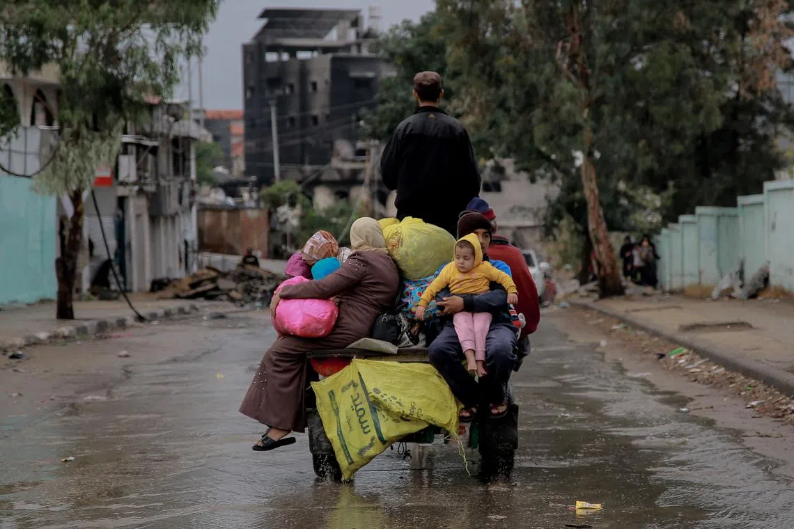 Palestinians transporting belongings in Gaza City on Nov 27, 2023, on the fourth day of a truce between Israel and Hamas. 