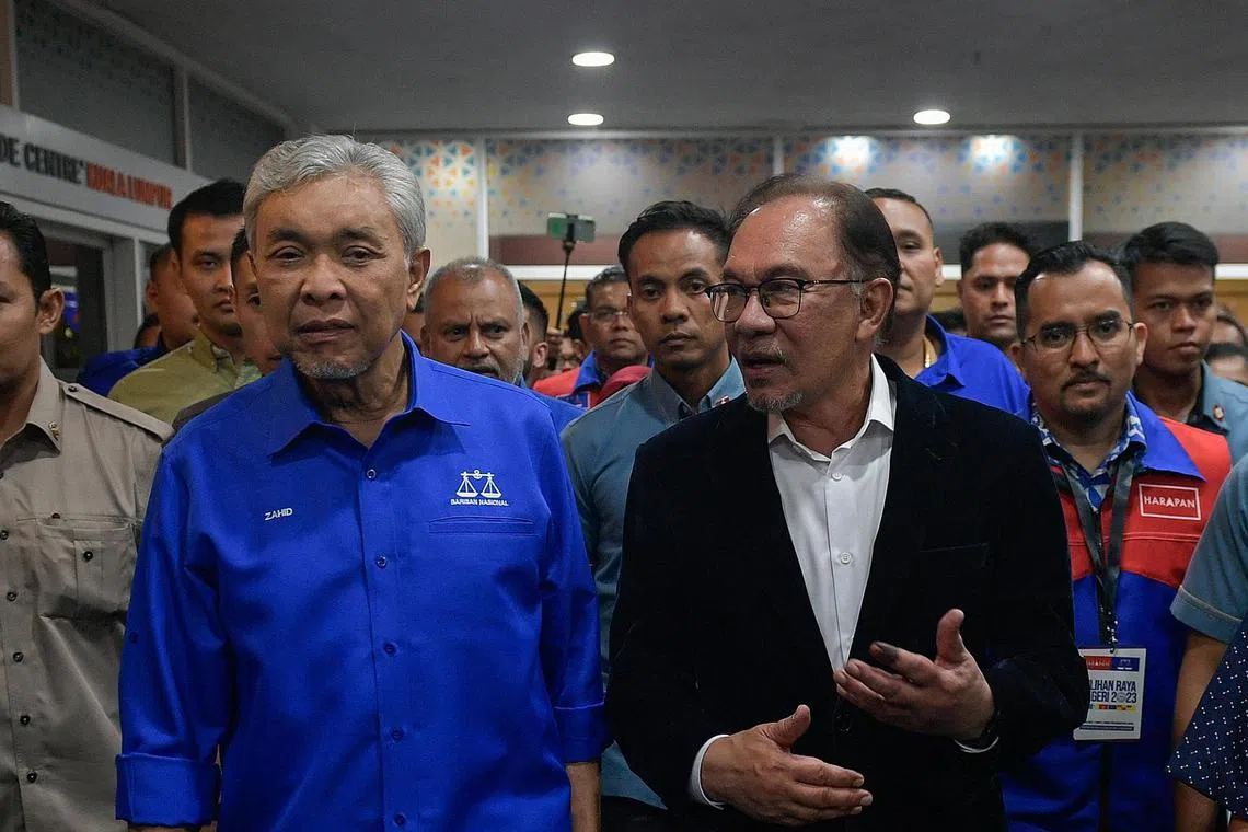 The dropping of graft charges against Malaysia DPM Zahid Hamidi (left) has led to a questioning of PM Anwar Ibrahim's Reformasi credentials. 