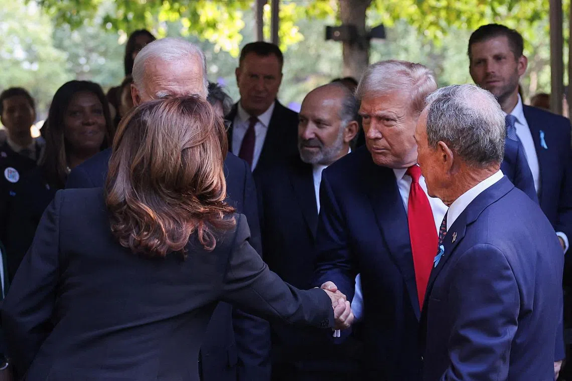 Former US president Donald Trump (right) shaking hands with Vice-President Kamala Harris at a ceremony marking the 23rd anniversary of the Sept 11, 2001, attacks in the US.