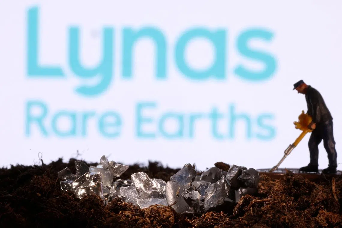 FILE PHOTO: A small toy figure and mineral imitation are seen in front of the Lynas Rare Earths logo in this illustration taken November 19, 2021. REUTERS/Dado Ruvic/Illustration/File Photo