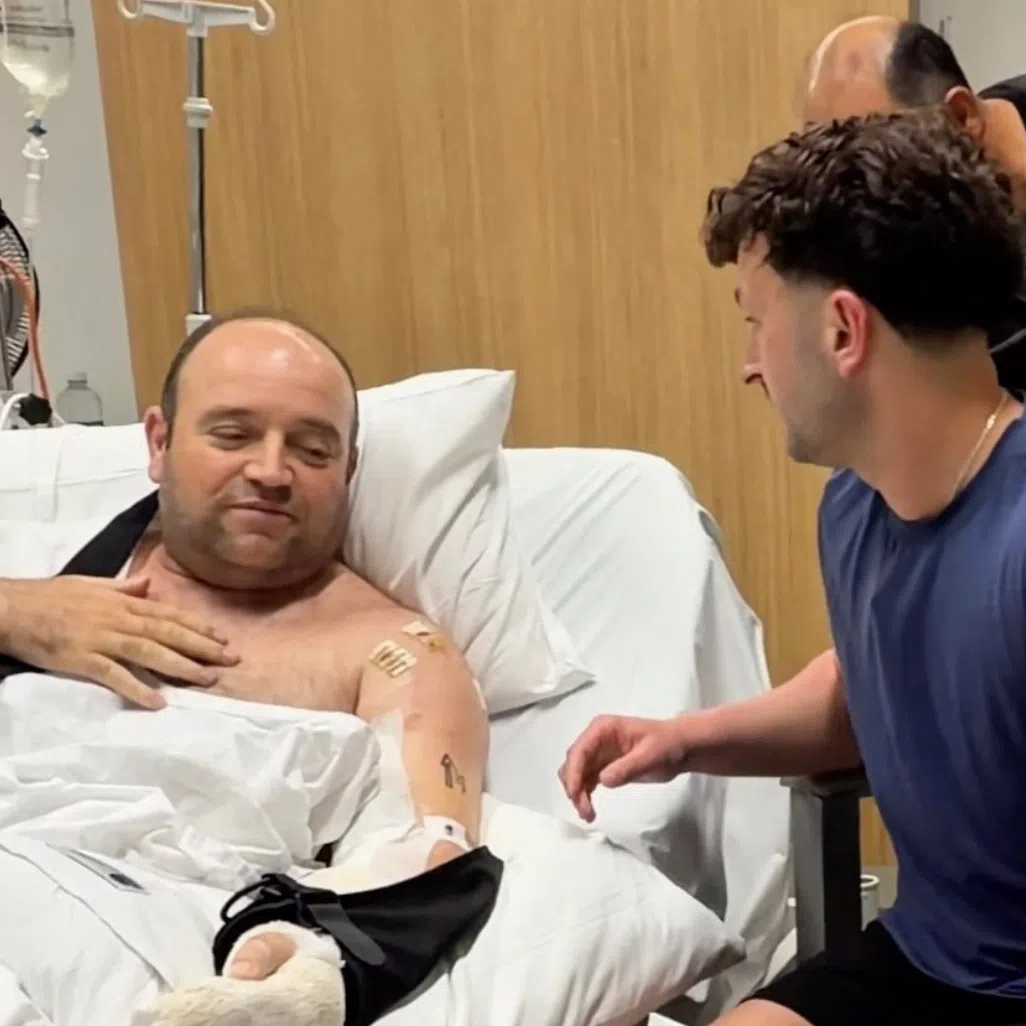 Influencer Zachery Dereniowski gives a check of A$2,533,585 to Mr Ahmed al Ahmed, the bystander who is hailed as the "Bondi hero".