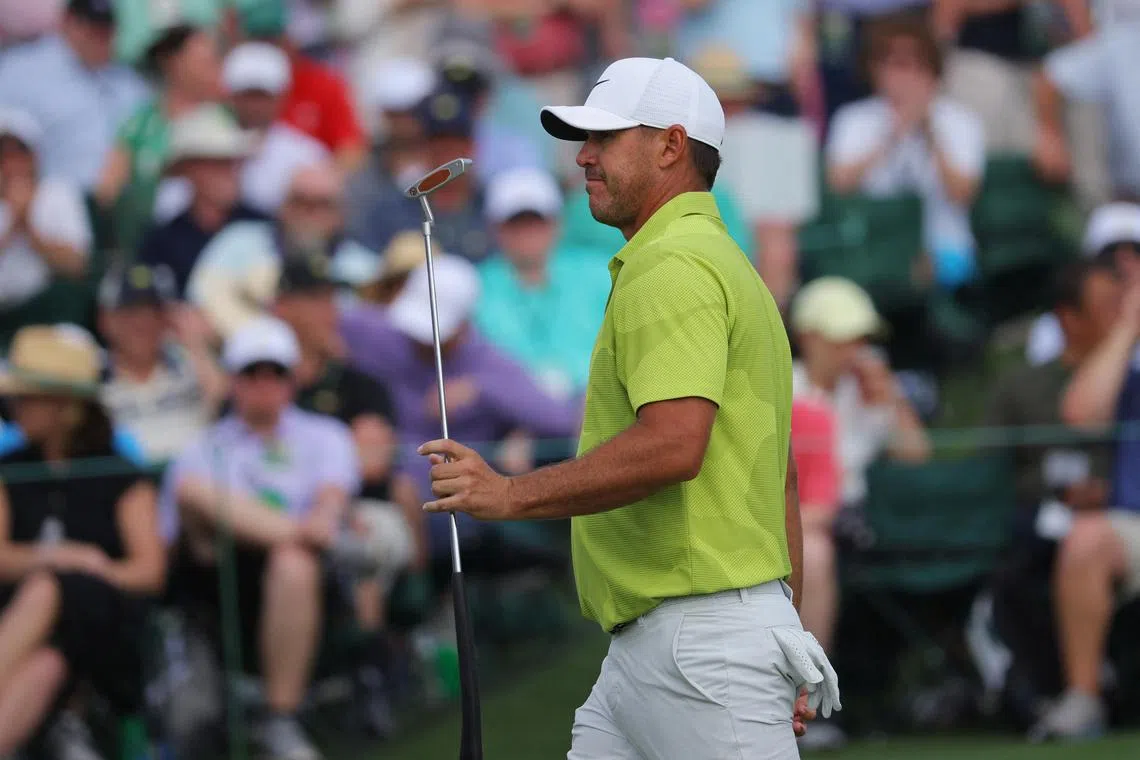 Brooks Koepka reacts after putting for a birdie on the 18th hole to complete his first round.