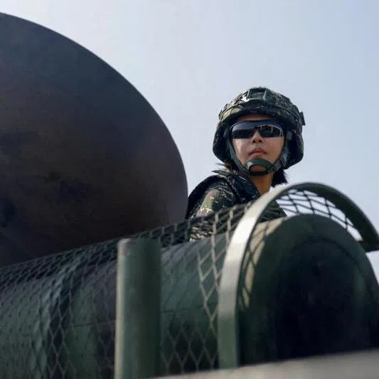 A soldier sits atop an AAV7 amphibious assault vehicle during an annual military exercise in Kaohsiung, Taiwan, on Jan 29, 2026.