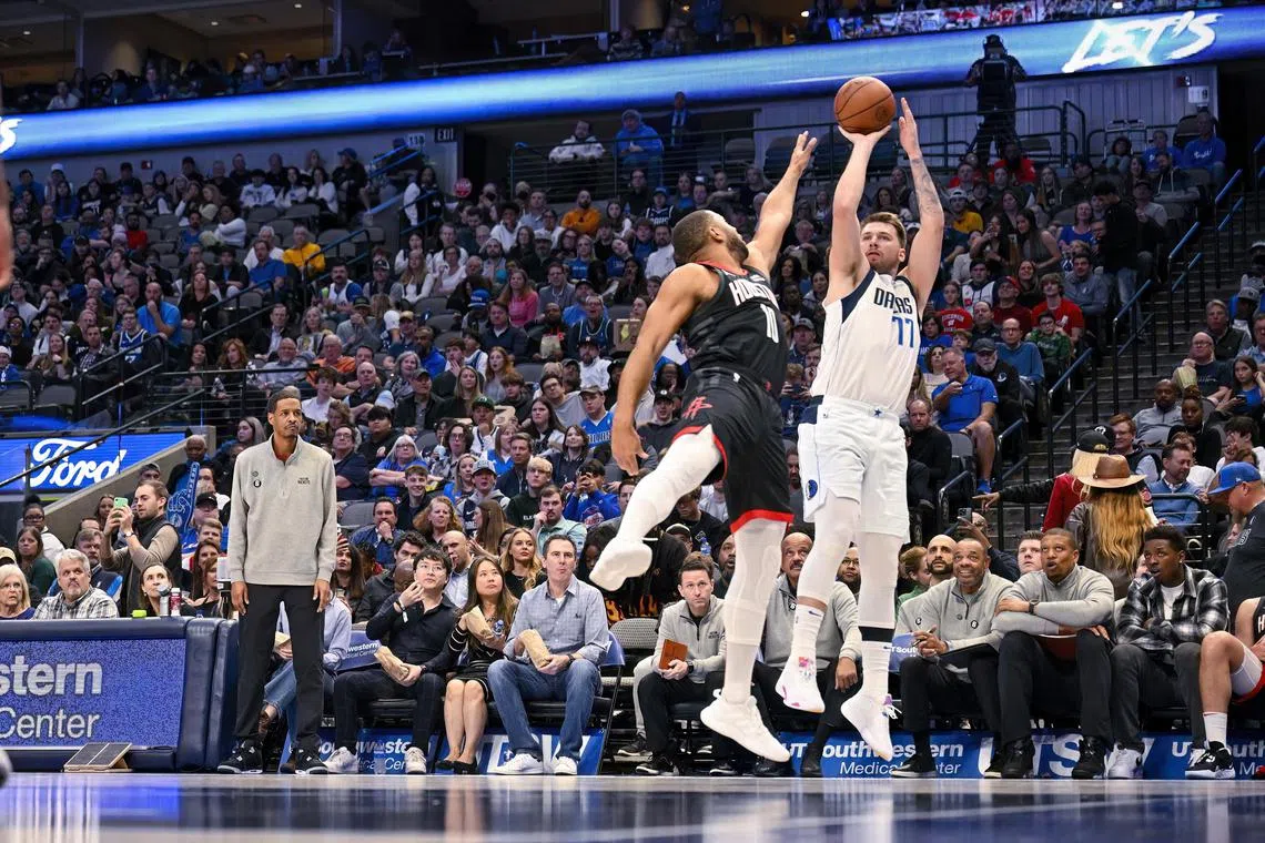 Dallas Mavericks guard Luka Doncic shoots over Houston Rockets guard Eric Gordon during the second half at the American Airlines Centre.