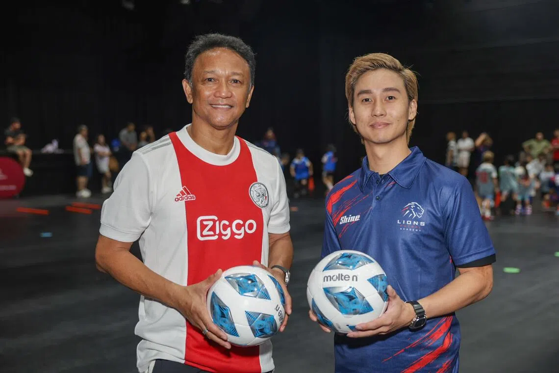 Singapore football legend Fandi Ahmad (left) posing for a photo at the launch of the Lions Futsal Academy at *SCAPE on Aug 9 with its co-founder Kenneth Kwang.