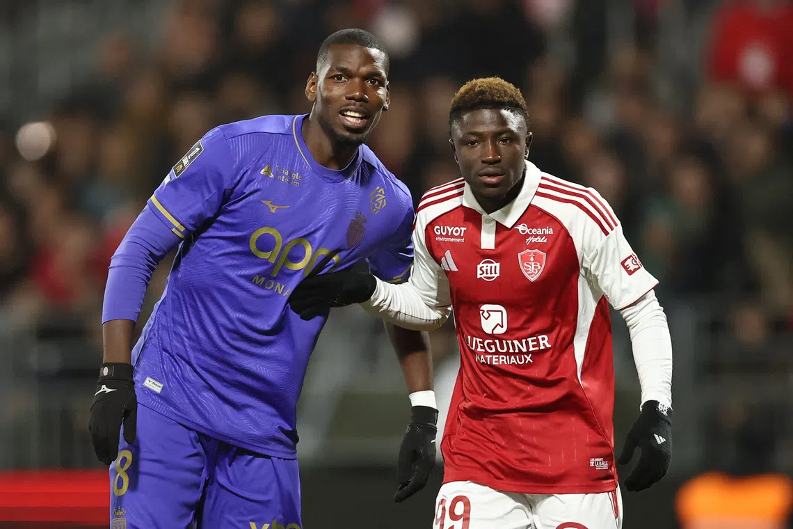 Soccer Football - Ligue 1 - Brest v AS Monaco - Stade Francis-Le Ble, Brest, France - December 5, 2025 AS Monaco's Paul Pogba in action with Brest's Pathe Mboup REUTERS/Stephane Mahe