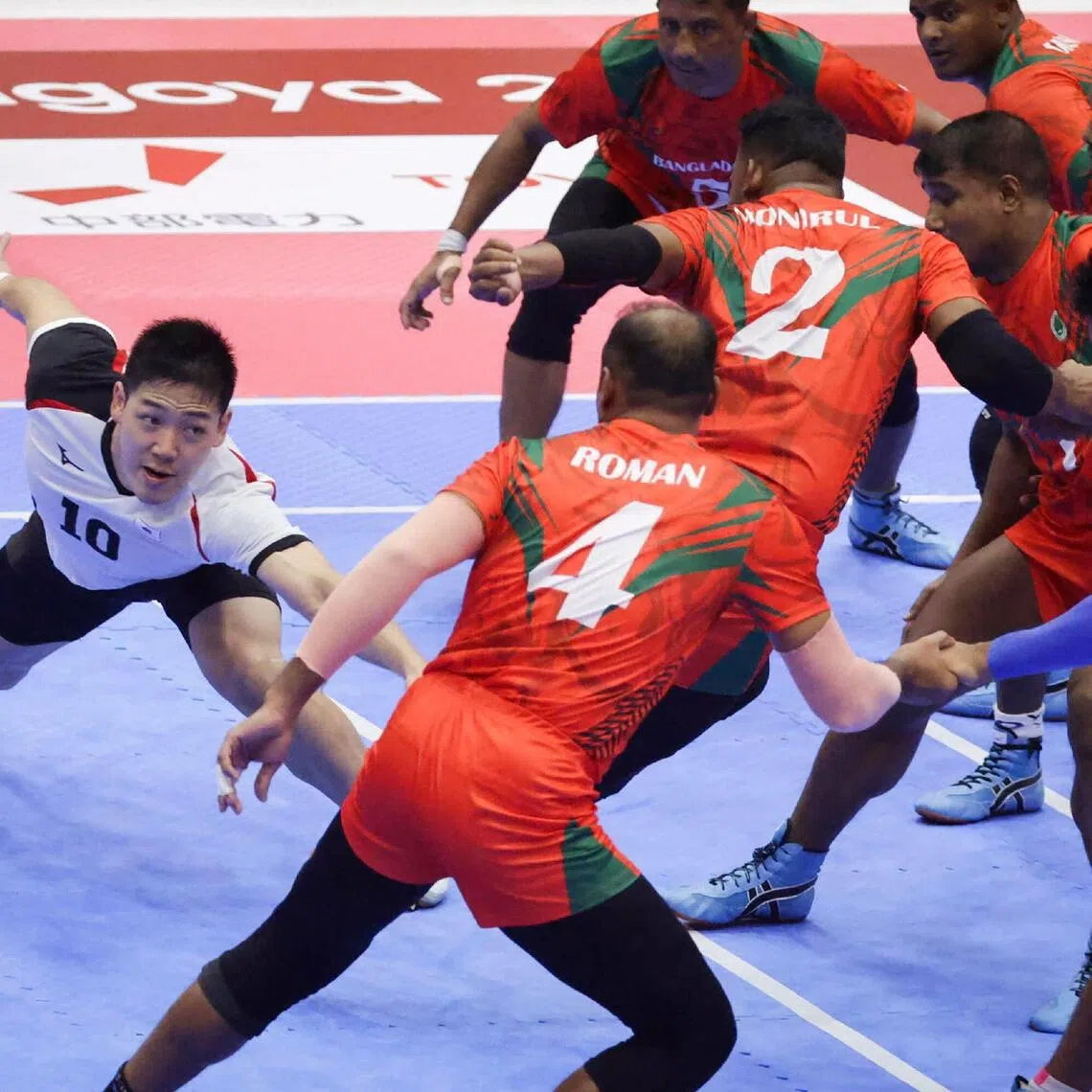 Japan’s Shoya Suzuki reaching out to tag Bangladesh players in their kabaddi group-stage match at the Aichi-Nagoya Asian Games on Sept 22, when the hosts emerged as 40-37 winners.