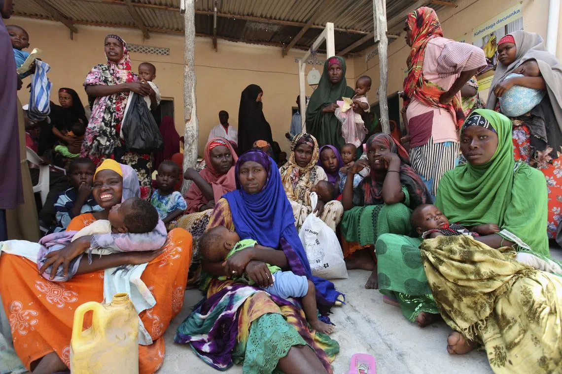FILE PHOTO: Internally displaced Somali women wait for medicine at a Save the Children UK clinic at their camp in Hodan district of Somalia's capital Mogadishu, November 21, 2012. REUTERS/Feisal Omar/File Photo