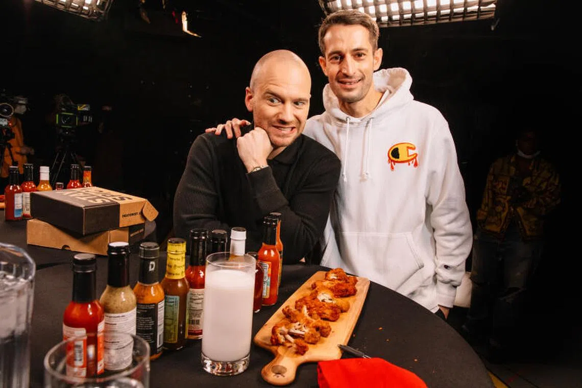 Sean Evans (left), host of the YouTube show Hot Ones with creator Chris Schonberger (right), in March 2023. BuzzFeed said on Dec 12, 2024 that it had reached a deal to sell the company behind the popular interview show for US$82.5 million.