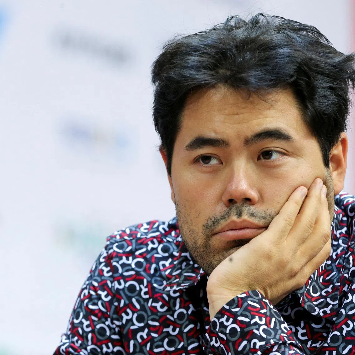 FILE PHOTO: Chess - FIDE World Rapid and Blitz Championships 2022 - Blitz Open - Almaty, Kazakhstan - December 30, 2022. Hikaru Nakamura of the U.S. sits in front of a chess board during a game. REUTERS/Pavel Mikheyev/File Photo