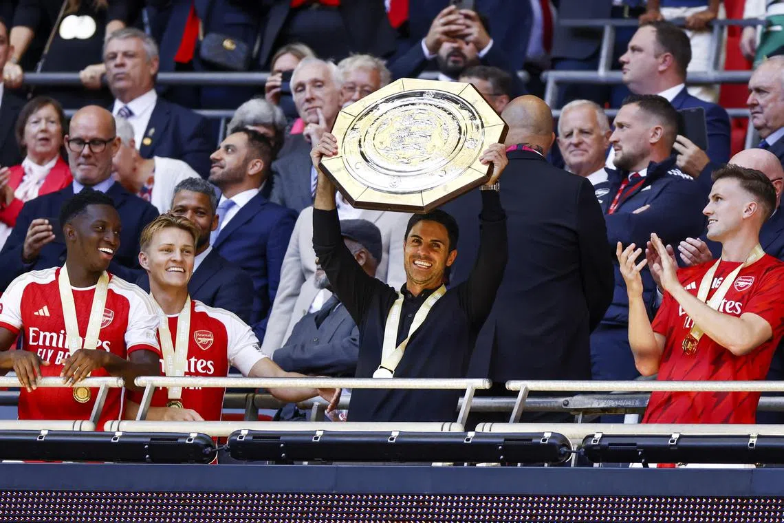 Arsenal manager Mikel Arteta lifting the trophy after the FA Community Shield match against Manchester City.