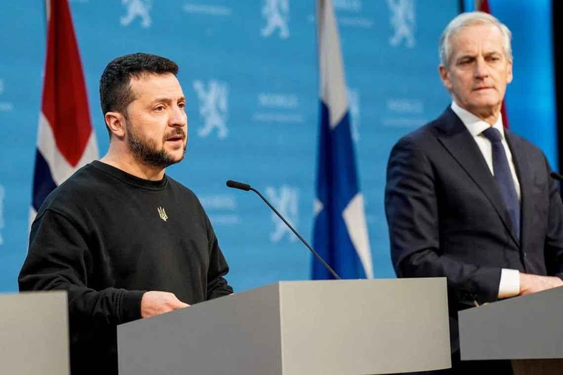 Ukraine's President Volodymyr Zelenskiy speaks next to Norway's Prime Minister Jonas Gahr Store as he attends a press conference during a Nordic summit in Oslo, Norway, December 13, 2023. NTB/Cornelius Poppe via REUTERS